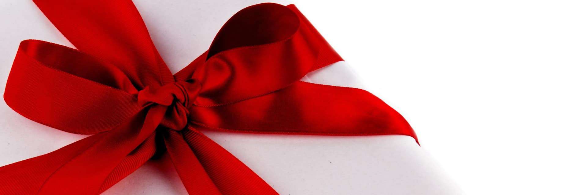 Photo of a red bow on a white gift box