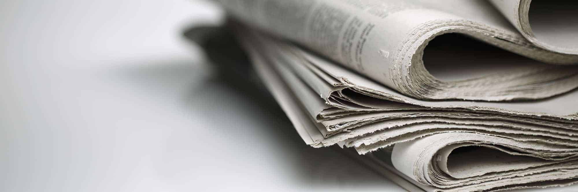Photo of newspapers against plain background shot with very shallow depth of field